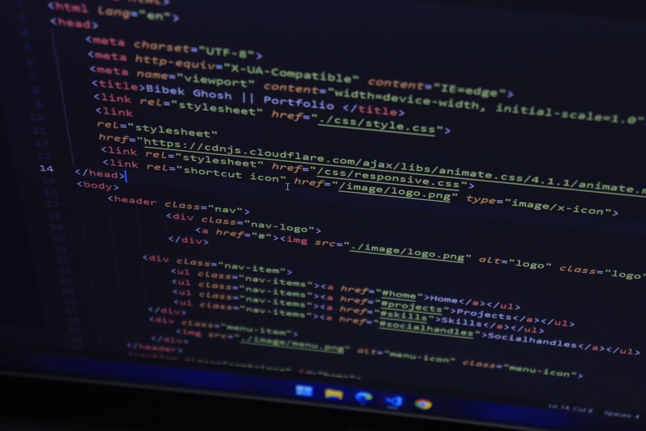 Detailed close-up of HTML code shown on a computer monitor, ideal for technology-focused themes.